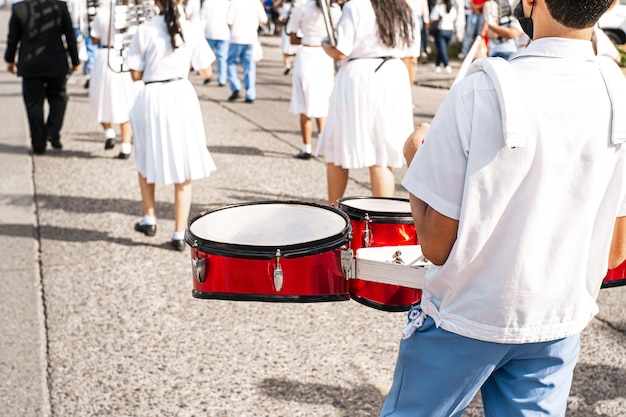 Hands of a percussionist playing an instrument in a parade