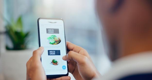 hands phone and man order food online with menu for dinner meal or supper at home technology restaurant and person scroll with cellphone screen on internet for gourmet dish for lunch at apartment