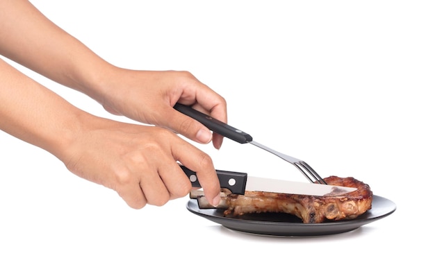 hands picking up delicious BBQ ribs by fork and knife isolated on white background