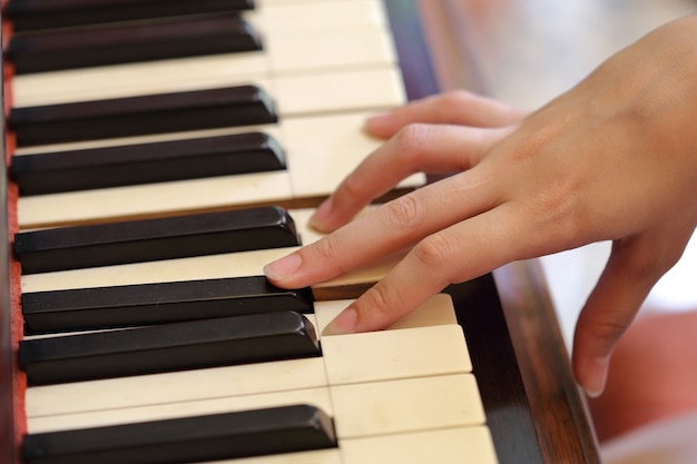 hands playing the classic wood piano