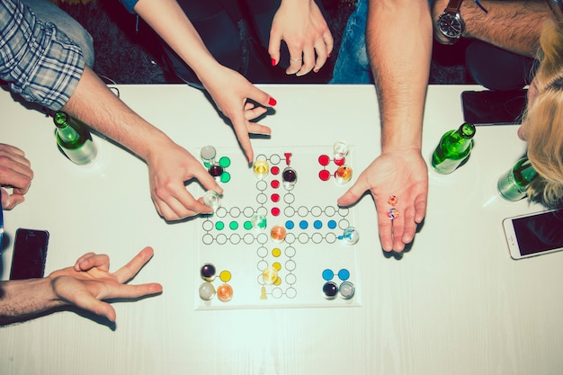 Hands playing with a boardgame at the party