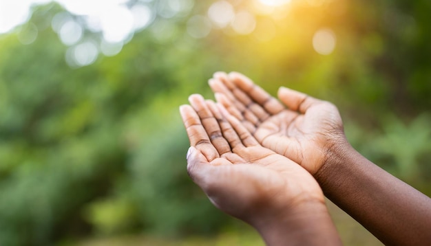 Hands in prayer open in respect against serene nature backdrop