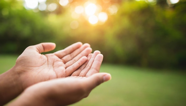 Hands in prayer open in respect against serene nature backdrop