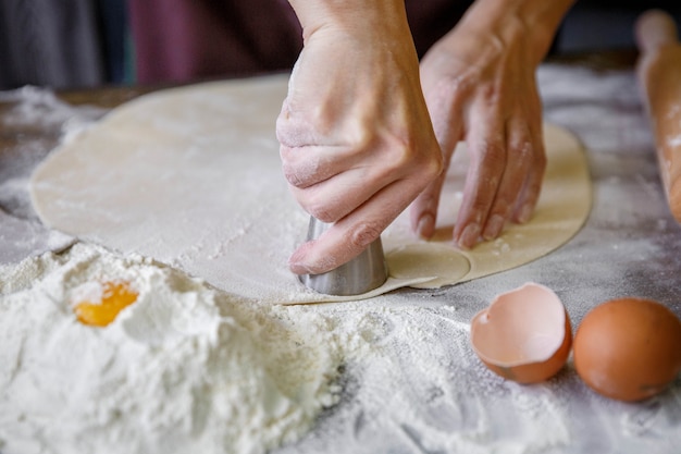 Hands preparing dough for dumplings