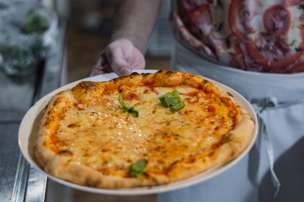 hands preparing pizza