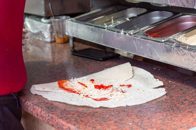 Hands of a professional chef who makes Shawarma