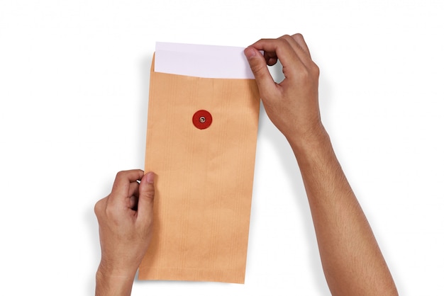 Hands pull the white paper from envelope 