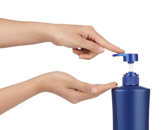 hands pumping out  shampoo from bottle isolated on white background