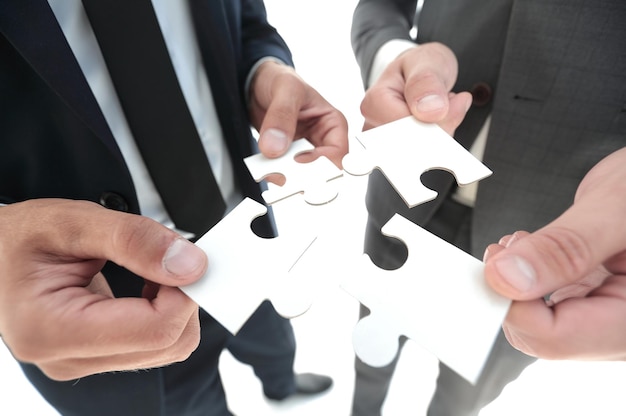 Hands and puzzle Team isolated on white background