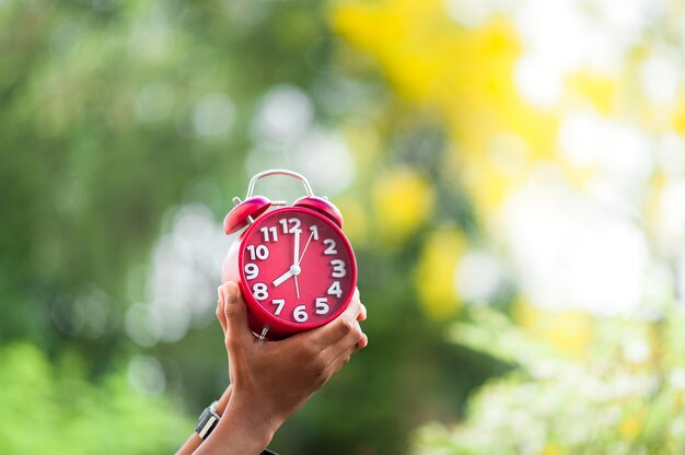 Premium Photo | Hands and red clocks
