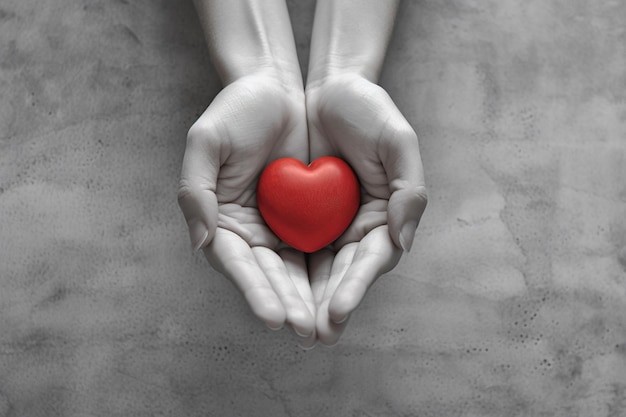 A hands and red heart with a white background