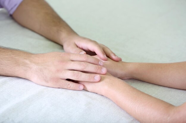 Hands of romantic couple over a restaurant table