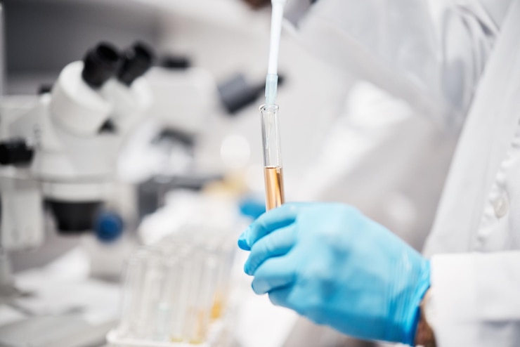 Photo hands science and tube for research in lab with liquid medicine or pharma product with gloves for safety innovation scientist and chemistry in laboratory for study pharmaceutical trial or goal