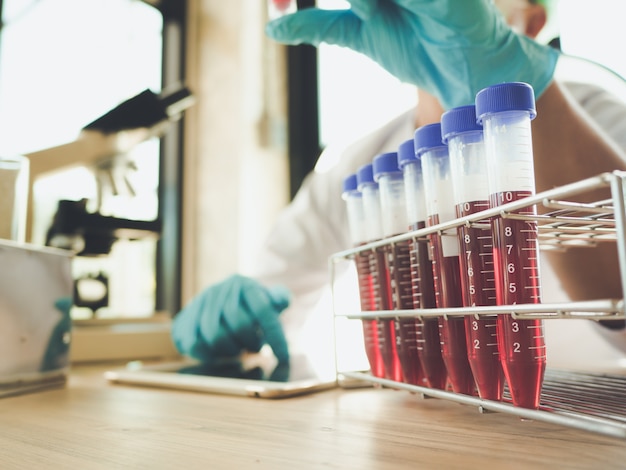 The hands of scientists hold pipette and test tube in the lab for  education and research