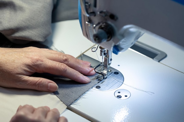 Hands of a seamstress at work closeup Seamstress workplace Small business