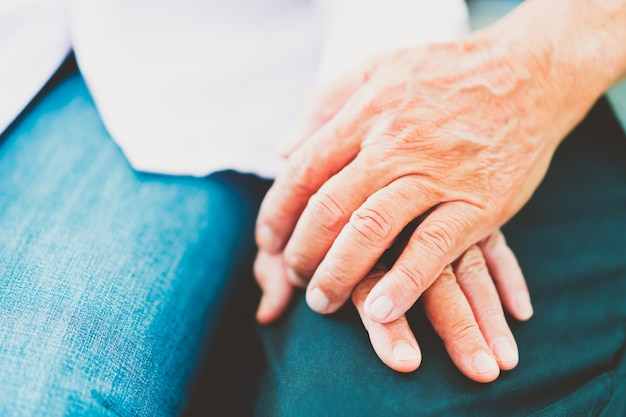 Hands of senior asian couples support each other, selective focus