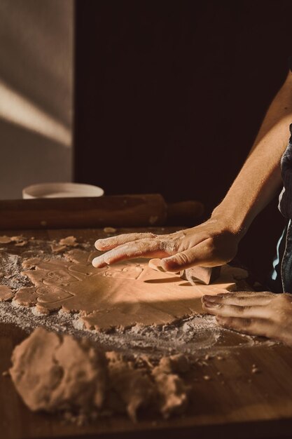 Hands shaping the dough to make cookies