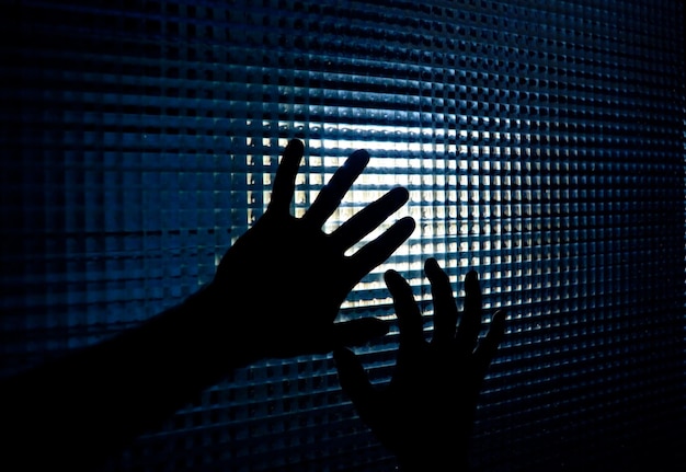 hands silhouette. hands of one person trying to get out