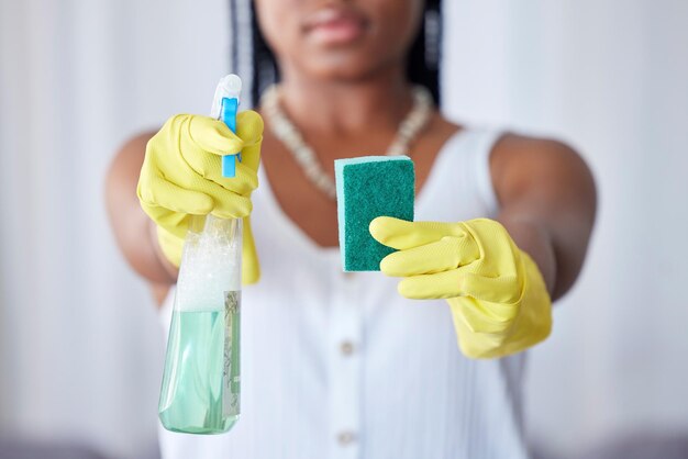 Foto flacone spray per le mani e spugna con un detergente per donne nere in una casa per l'igiene o la pulizia dei lavori domestici spruzzatura di guanti e attrezzature con una cameriera femminile in una casa per le pulizie domestiche