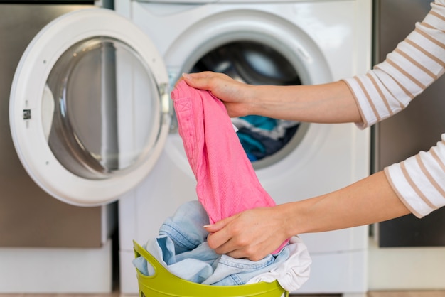 Hands stretching clothes in laundry room