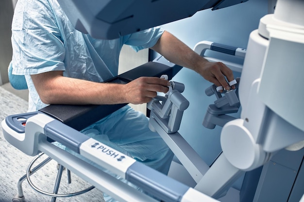 Hands of a surgeon at a computer robot medical robot Robotic Surgery