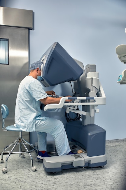 Hands of a surgeon at a computer robot medical robot Robotic Surgery