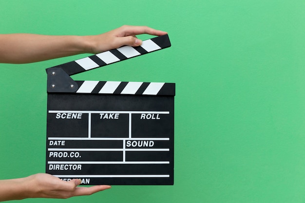 Hands take movie clapper board slate equipment film action for shouting the movie.