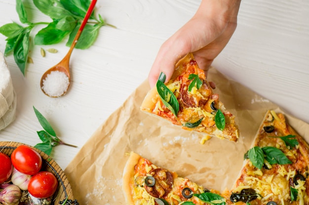 Hands taking slices of pizza. Hand holding slice pizza.