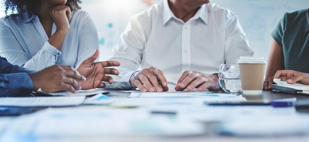 Photo hands teamwork and collaboration with a team of business people in a meeting for planning strategy and vision talking about the mindset and mission of company growth and development for the future