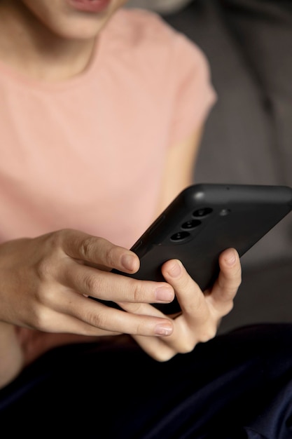 hands of a teenage girl using a smartphone