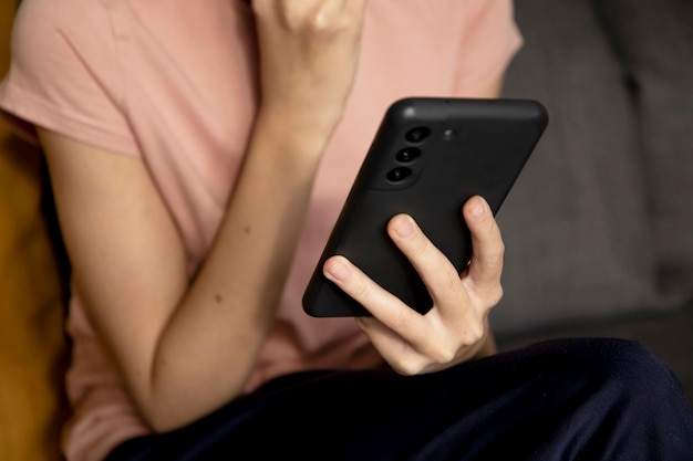 hands of a teenage girl using a smartphone