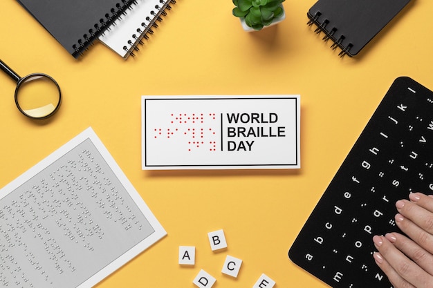 Hands touching braille alphabet keyboard