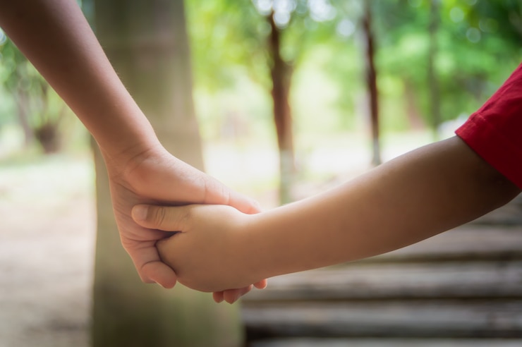 Photo the hands of two children which hand in hand