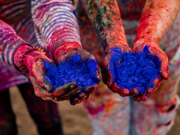 Hands of two young girls in the hands of the paint