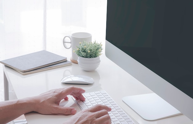 Hands typing on a computer keyboard