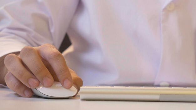 Hands typing on the keyboard Male hands or man office worker typing on the keyboard f