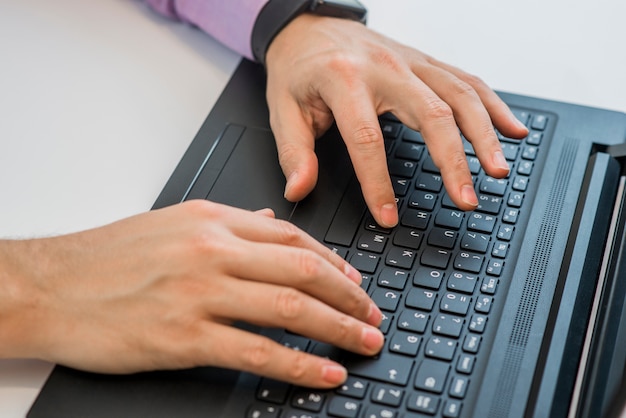 Hands typing in a laptop top view