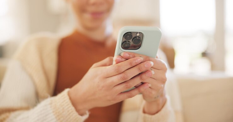 Photo hands typing and woman with phone on sofa thinking or laugh to relax in living room for texting web chat or blog girl smile and smartphone for click meme or social media on lounge couch in home