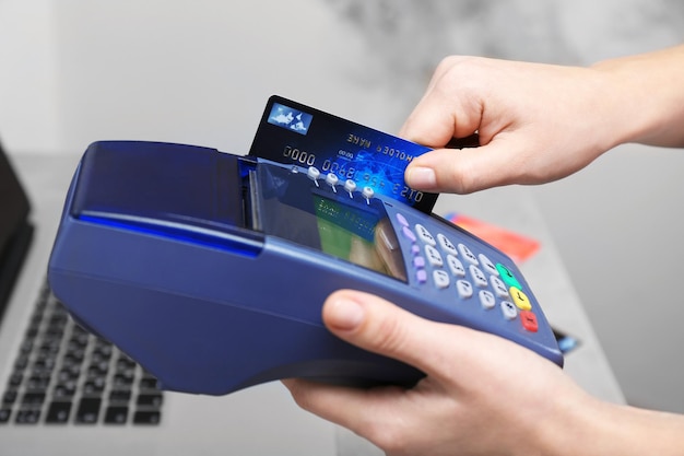 Hands using bank terminal for credit card payment