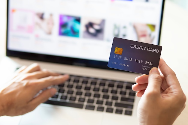 Hands using a laptop and credit card for online payment