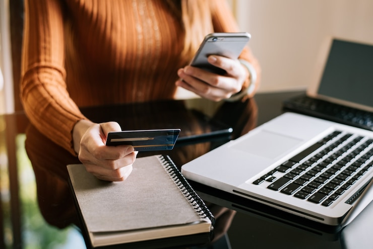 Photo hands using smartphone and holding credit card with digital layer effect diagram as online shopping concept