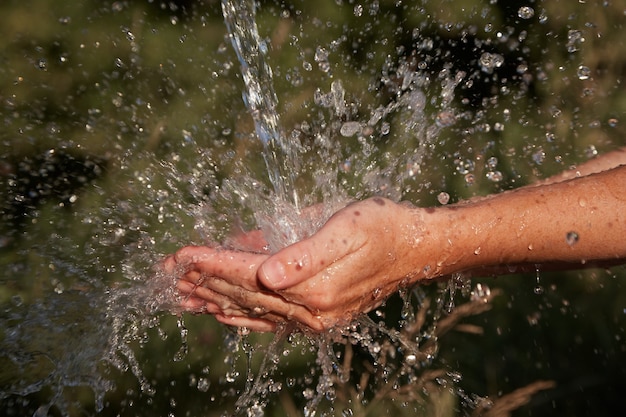 hands under the water jet