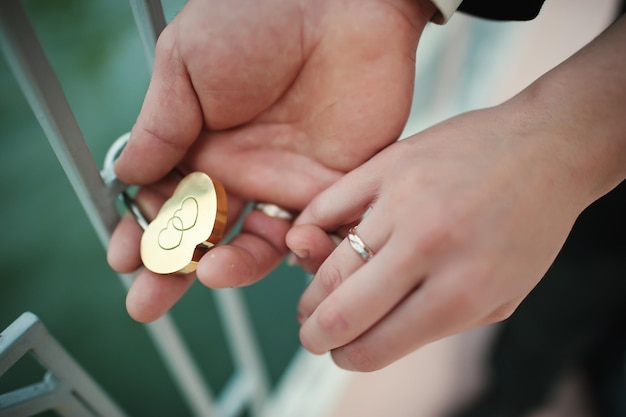 Hands wedding couple with lock and rings