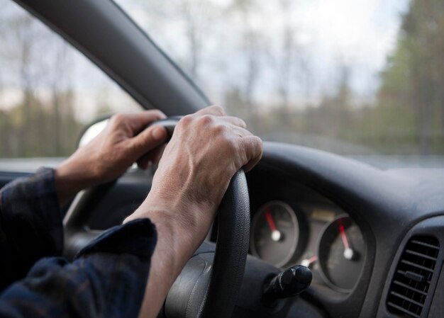 Photo hands on the wheel when driving at high speed from inside the car.