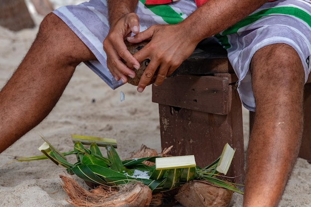 Hands while grating fresh coconut