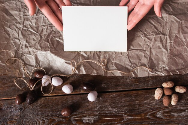 Hands with blank card on kitchen table