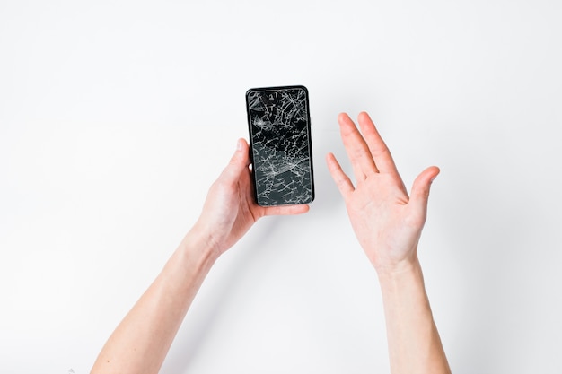 Photo hands with a broken smartphone