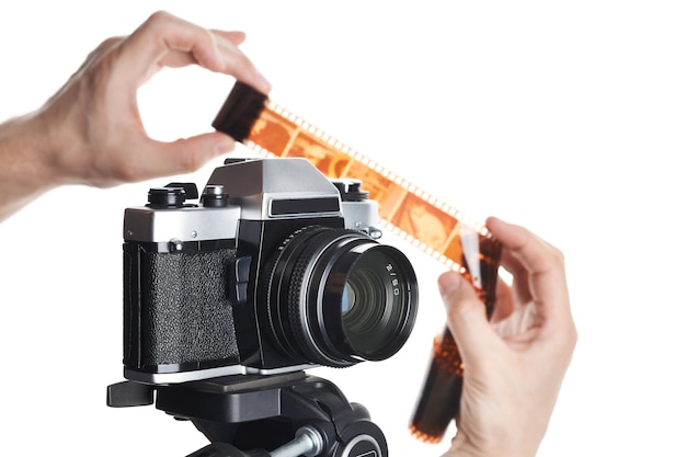 Hands with color negative near SLR camera isolated