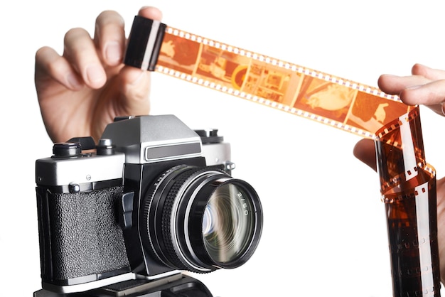 Hands with color negative near SLR camera isolated