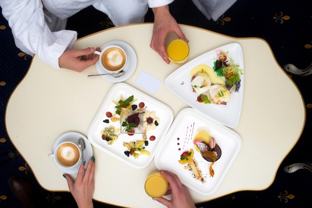 Hands with food and drinks